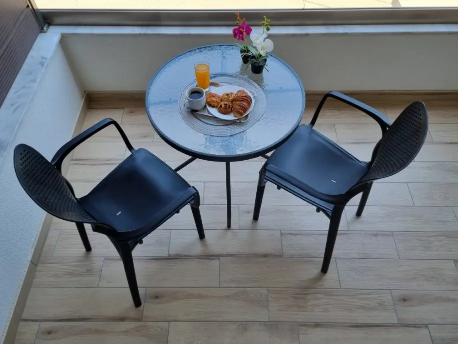 Small table with 2 chairs and lockable wardrobe on the balcony